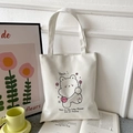 Minimalist white Oxford tote bag featuring cartoon bear and flower prints with text - White with Yeah Bear Print