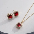 Detail of gold jewelry set with square red gems and clear crystals on white texture - Gold Square Red (HQ0001(24))