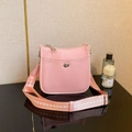 Pink lychee texture crossbody bag with silver twist lock and woven shoulder strap - Pink