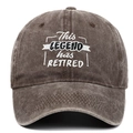 Close-up of white and black embroidery This Legend Has Retired on washed cotton baseball cap - Adjustable / Coffee