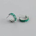 Detailed macro view of silver hoop earrings featuring emerald green rectangle zircons - Green Zircon (Silver Tone)