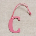 Close-up of pink leather letter C bag charm featuring detailed lychee grain texture - Letter C Pink