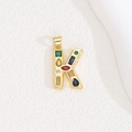 Close-up of golden letter K pendant with multi-colored cubic zirconia stones - Letter K
