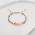 Detail of hand-woven bracelet with gold letter K charm and natural freshwater pearl - Letter K