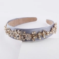 Close-up of Baroque headband with sparkling rhinestones and floral embroidery detail - Gray