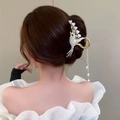 Detailed back view of a gold lily of the valley hair claw with pearls and tassels - Straw Lily Of The Valley