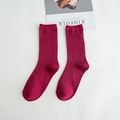 Dark red cotton ribbed crew socks for women displayed on a clean white fabric background - Burgundy