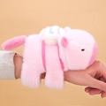 Pink Capybara plush wristband toy with white backpack shown on a wrist - Pink Sporty Capybara Slap Bracelet (Fixed Tail)