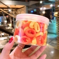 Colorful elastic hair ties in orange and beige tones stored in a clear plastic jar - 100 Pcs Jar / Yellow