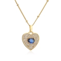 Close-up of gold heart necklace with micro-pave crystals and a central blue stone - Gold Color Oval Blue Zirconia