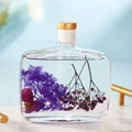 Reed diffuser variant featuring purple hydrangea and red globe amaranth in clear liquid - Lavender