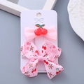 Pink handmade hair clips set for girls featuring cherry bow design on a white card - Cherry Resin