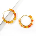 Detail of bohemian gold hoop earrings featuring hand-wrapped orange and yellow resin beads - Orange Yellow Translucent Beads / Orange Striped Agate