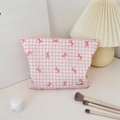 Close-up of pink checkered cosmetic bag with bow patterns and silver zipper detail - Pink Plaid Bow