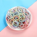 Colorful high elasticity hair bands for kids in a white tray on a dual-tone background - Medium Light Color Twisted 100pcs