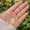 Makroaufnahme von Goldanhänger mit Jungfrau Maria Relief und funkelndem Kristallkreuz - Gold