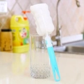 Blue long-handled sponge bottle brush with white wavy sponge head in a glass cup - Individual Bag / L Blue