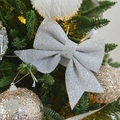 Sparkling silver glitter bow ornament hanging on a green Christmas tree branch - Silver Small Bowknot Set of 4 15CM