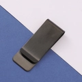 Macro view of minimalist black brushed stainless steel money clip on blue background - Brushed Black Money Clip