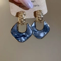 Close-up of gold hammered metal and blue marble acrylic pendant earrings on a card - 925 Sterling Silver Earring Post - Gold Frame - Ink Blue
