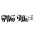 Macro detail of triple skull stud earrings in retro silver with S925 hallmark - Silver
