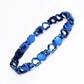 Macro shot of blue heart-shaped metal magnetic therapy bracelet with polished links - Blue