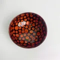 Handcrafted coconut shell bowl with natural wood inlay pattern and glossy finish - Orange Polka Dot Style
