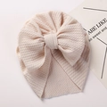 Close-up of beige waffle texture fabric and large bow on a warm baby turban hat - Khaki