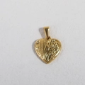 Macro view of a gold heart pendant with embossed floral patterns and a vintage finish - K19-Floral Heart / Gold