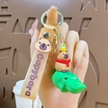 Cute Capybara riding green crocodile keychain with yellow wrist strap and gold hardware - Capybara Riding Crocodile