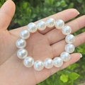 Classic white faux pearl beaded bracelet for girls worn on wrist with natural background - 12MM Cream White Pearl Bracelet