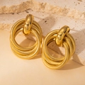Exaggerated golden multi-layered rope texture hoop earrings on warm stone background - Twisted Rope Multi-Hoops (BJGE0709)
