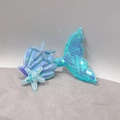 Detail of sequined mermaid tail hair clip with iridescent shell and glittery blue stars - Blue Mermaid