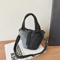 Denim patchwork bucket bag in black and gray with top handle and shoulder strap - Black