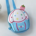 Detail view of cartoon cupcake shaped silicone kids bag with strawberry top and strap - Blue