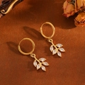 Detail of gold hoop earrings with leaf pendants and sparkling white zircon stones - Gold Leaf Hoop Earrings (T029)