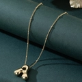 Macro shot of gold balloon style letter A pendant on a delicate ball chain - Letter A