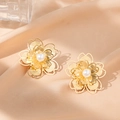 Elegant gold hollow flower earrings with white pearl centers on champagne silk background - Pearl Double Layer Flower