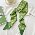 Grass green twilly scarf with white geometric patterns styled on a white shirt collar - Tender Green Double C Buckle