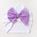 Detail of baby turban hat with a large purple bow and gold foil polka dots - White with Purple Bow