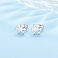 Macro shot of silver snowflake earrings with ball back closures on blue silk - Snowflake - Silver