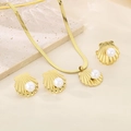 Detail of gold seashell jewelry set with pearls on elegant silk and stone background - Scallop Shaped Pearl Jewelry Collection (KS220722-LX)