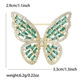 Exquisite gold butterfly brooch with cubic zirconia and green rectangle gemstone accents - Green