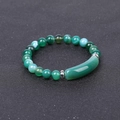 Macro view of green aventurine bead bracelet with silver metal spacers on a textured fabric - Striped Green Agate
