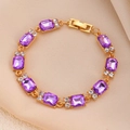 Elegant gold bracelet with emerald-cut purple crystals and diamond accents on silk background - Gold Eight Rectangle Purple Gems Bracelet (WG-0421)