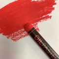 Vibrant red oil pastel crayon with black wrapping showing smooth texture on white paper - Vermilion