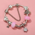 Detail of DIY cat charm bracelet with pink glass beads and silver paw print pendants - Sl023318/1216-17