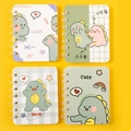 Set of four A7 mini spiral notebooks featuring green dinosaur designs and gold coils - Dinosaur Baby