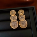Macro shot of three-tier golden hollow mesh earrings on a black textured jewelry box - Silver Pin - Three Tier Hollow Circle / Gold