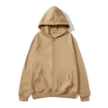 Detail of khaki zip-up hoodie featuring ribbed cuffs and kangaroo pockets on fabric - Camel